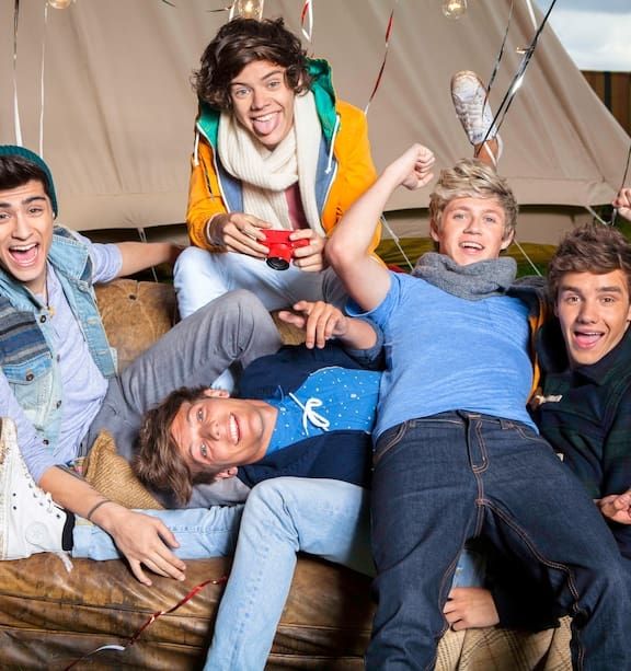 Zayn Harry Louis Niall and Liam being their chaotic selves and smiling and doing funny faces while piling up on a couch