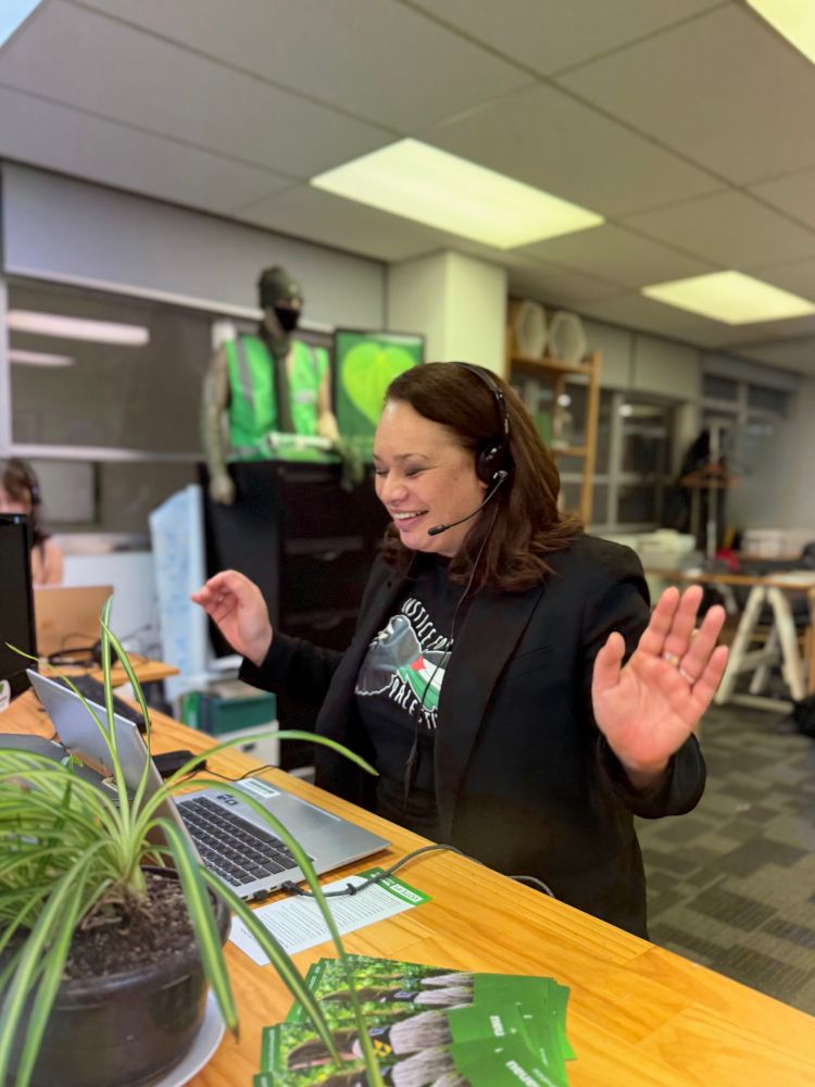 Tory Whanau on the phones at green office 
