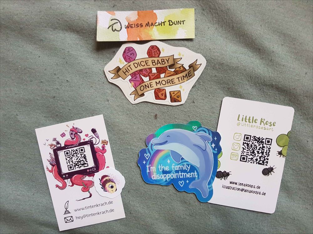 Sticker featuring dice and a a banner that reads "hit dice baby one more time", sticker of a dolphin that reads "I'm the family disappointment" and sticker of a cute little bumblebee