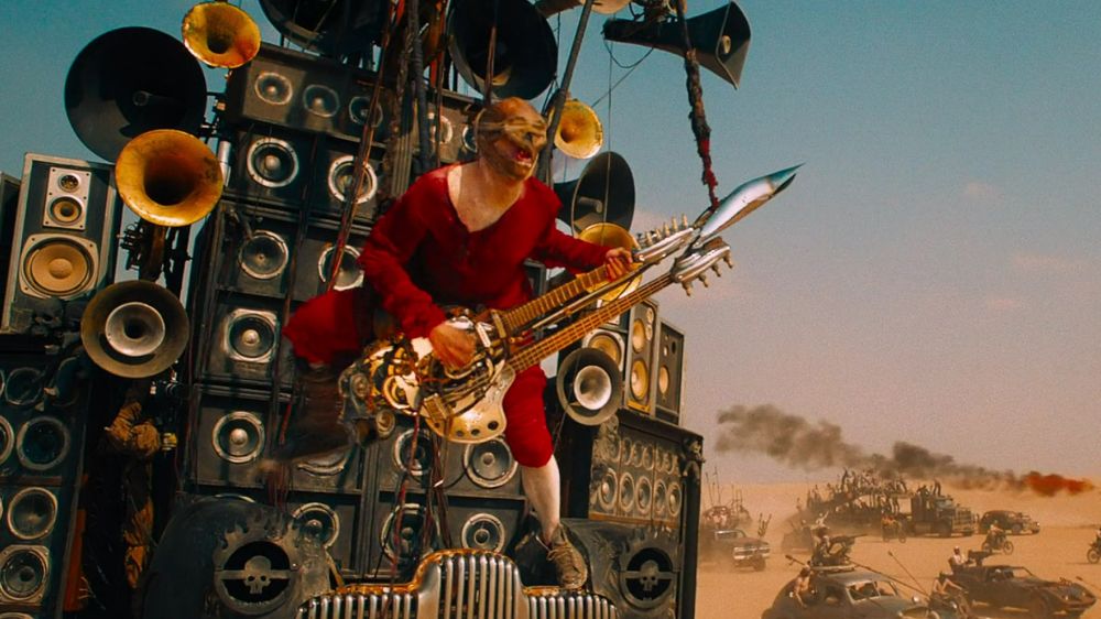 "Mad Max: Fury Road"'s Doof Warrior, strapped with his guitar and amplifiers to the front of a truck. He is not at this moment emitting fire.