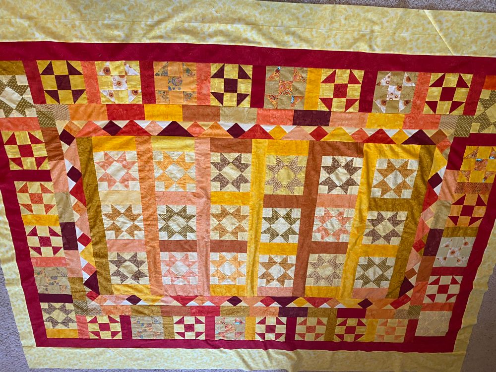 Hand sewn quilt in sunshine colors