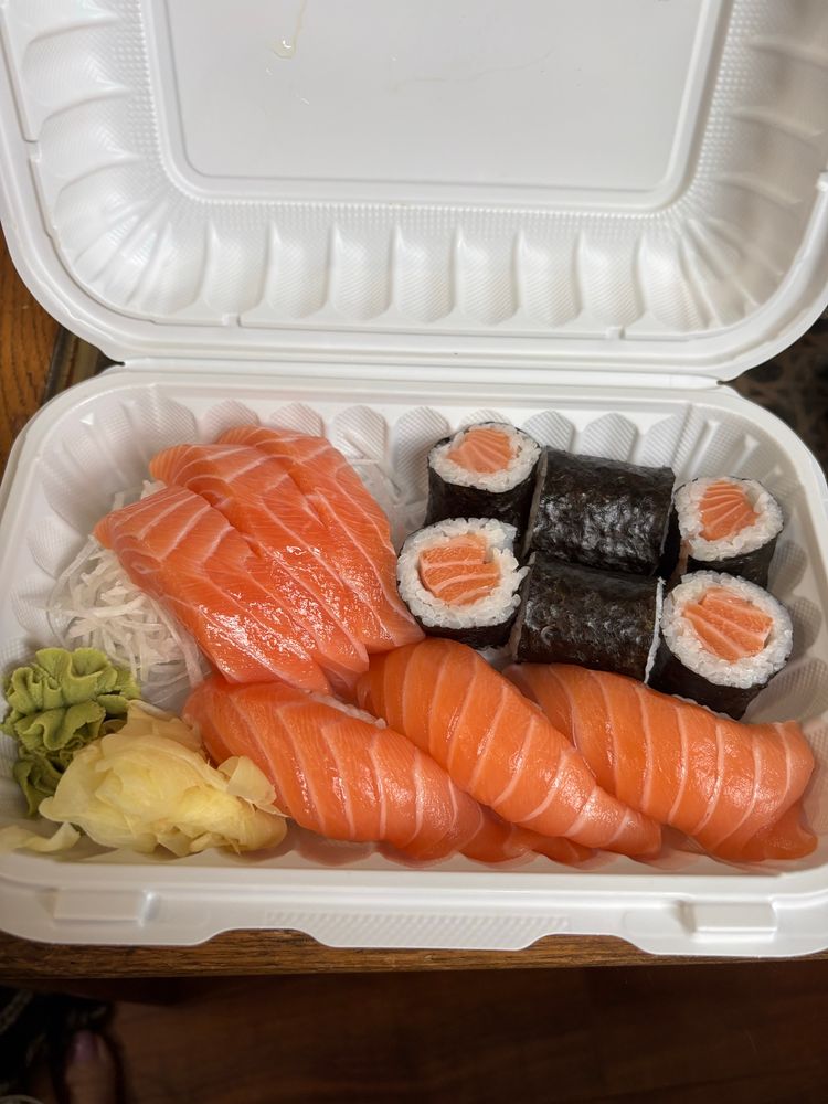 An abundance of salmon sushi. 3 pieces of sashimi, 3 nigiri, and 6 maki. 