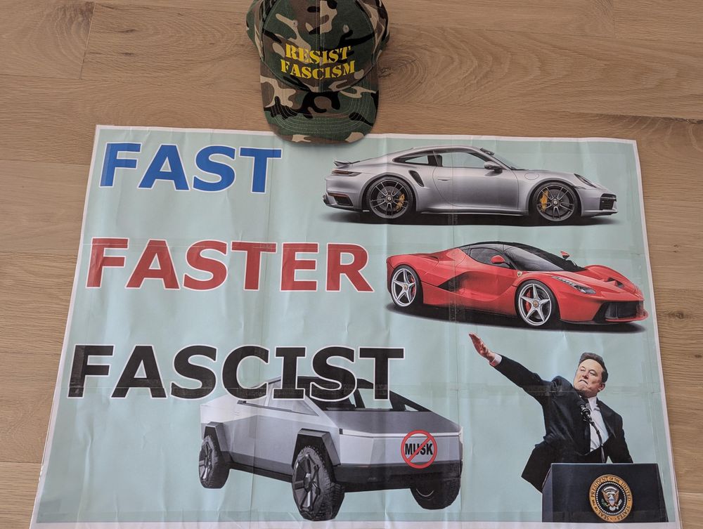 A protest poster laying on a wood with images of a Porsche, Ferrari and Cyber truck stacked vertically. The cybertruck sits next to an image of Musk giving a Nazi salute. Next to each car is a label reading "FAST" (Porsche), "FASTER" (Ferrari), "FASCIST" (Cybertruck)

Next to the poster is a camo baseball cap with yellow letters that read, "Resist Fascism"