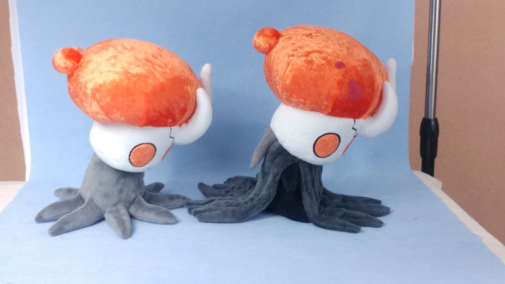 The earlier version of Broken Vessel is pictured alongside the final prototype for comparison. Instead of a body and cape, their body is simply a kinda stump from which leg-tentacles extrude. Originally, I was instructed to make their body like the Shade plushie, just with more tentacles. I suppose the idea was that it simplified BV's body, so we didn't have to make the whole complicated body and cape. Well, sometimes it's best to do things without any shortcuts. So I went rogue, design-wise, and made the body and cape without further oversight and was like "Here! What do you think??"