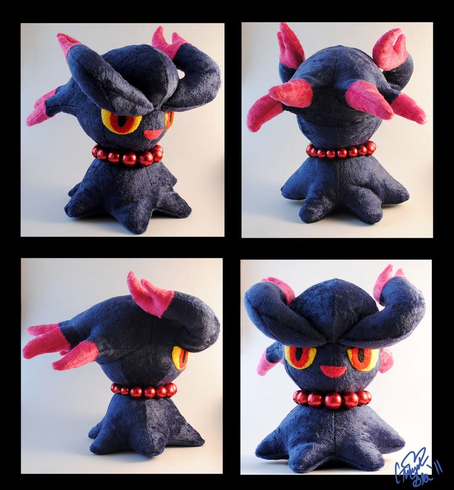 A Misdreavus plushie seen from four angles. I was so happy with the pattern I created here, at how curvy the shapes are and how balanced the whole plushie is. I mostly used crushed panne, which gives the plushie a mottled sparkle. I found a perfect set of beads in a craft store that was used for the necklace. The eyes and mouth was hand-appliqued fleece plus some needle felting.