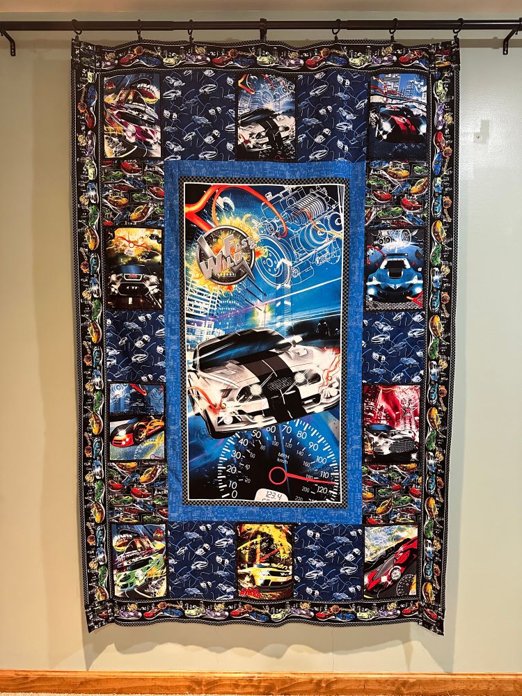 Quilt top made with Fast and Wild fabric featuring Hot Wheels style cars. 
