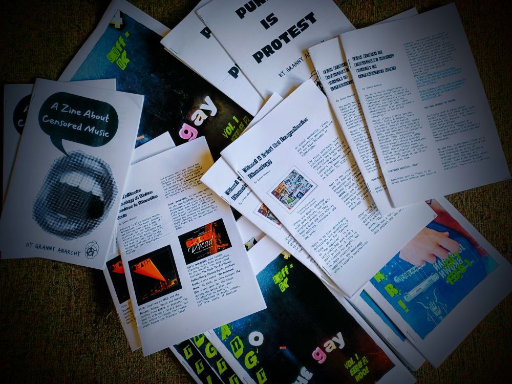 Zines scattered across a green background 