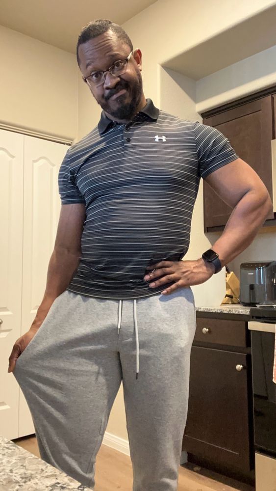 Joshua wearing a polo shirt and sweatpants