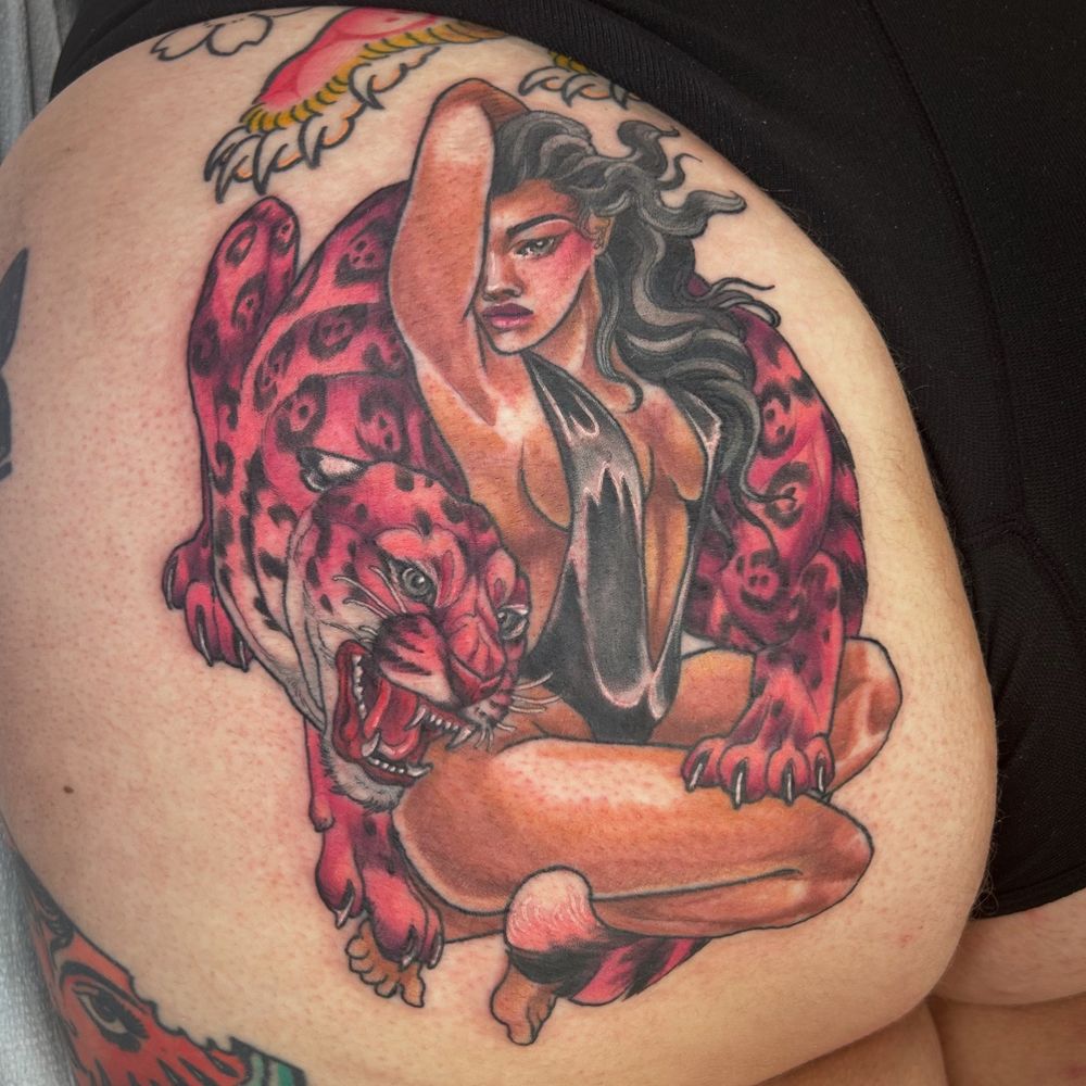 Buttcheek tattoo of a busty lady crouching with a hot pink jaguar 