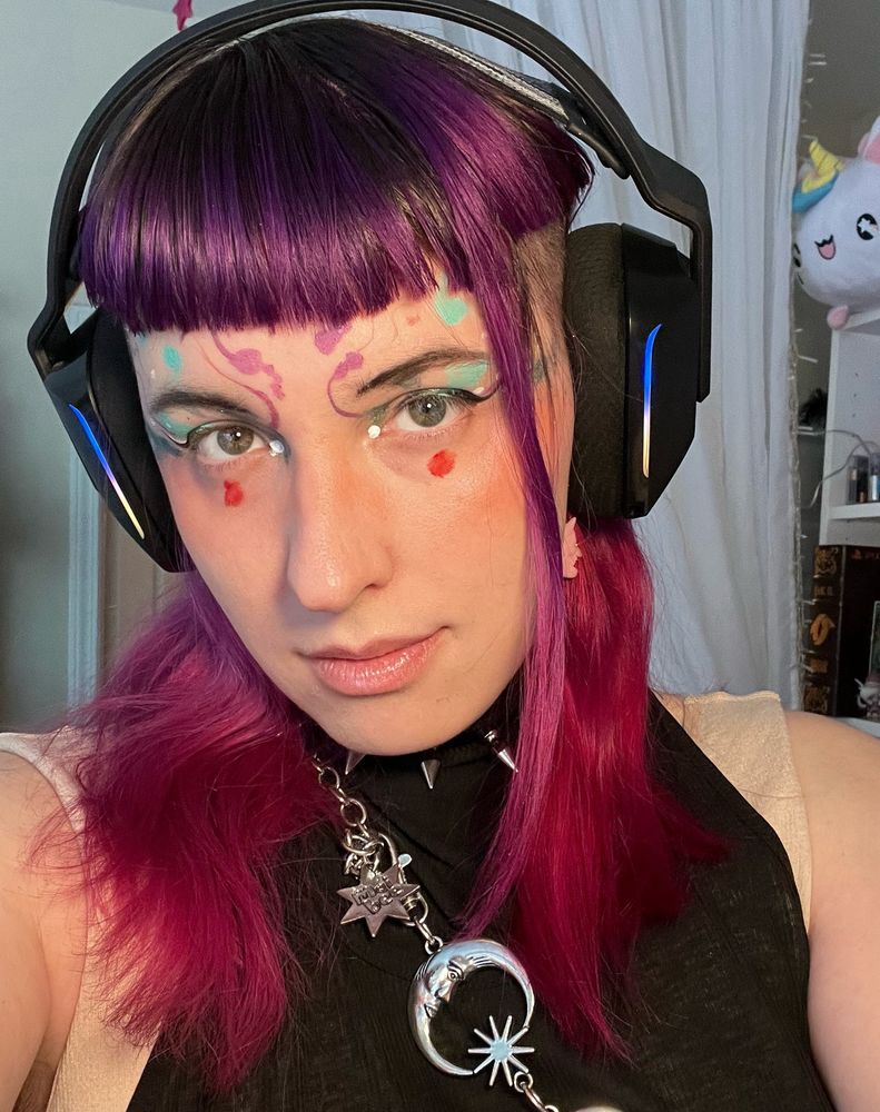An image of ubedemon close up wearing colorful makeup
