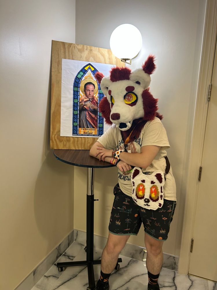 A furry next to a picture of Tony Soprano as the St of gabagool