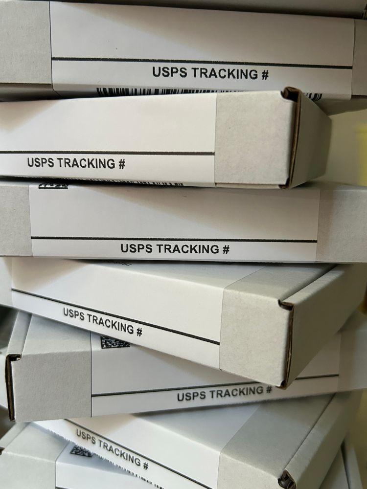 A stack of packaged orders ready to ship out!