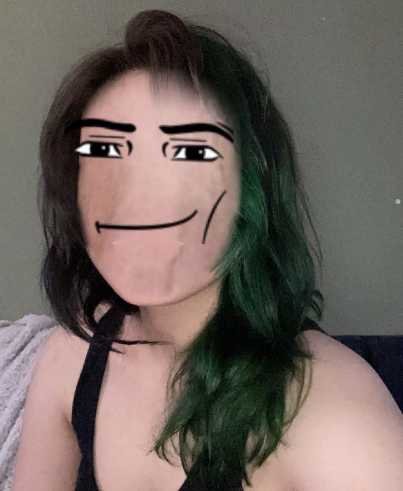 person with split dye black and green hair with man roblox face 