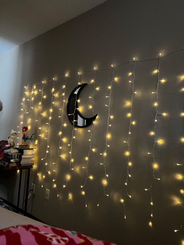 Lights cascading down a wall with a moon mirror. The viewer is also treated (is treated the right word? Dunno) to a tiny bit of my leg & a bit of Christmas sleep shorts. 