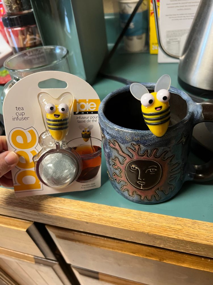 Tea ball strainers with a silly googly-eyed bee perched on the cup to hold in place. 