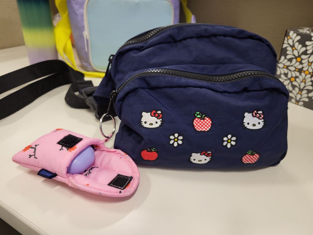 Hello Kitty Baggu purse with an even smaller Baggu earbud holder attached to it