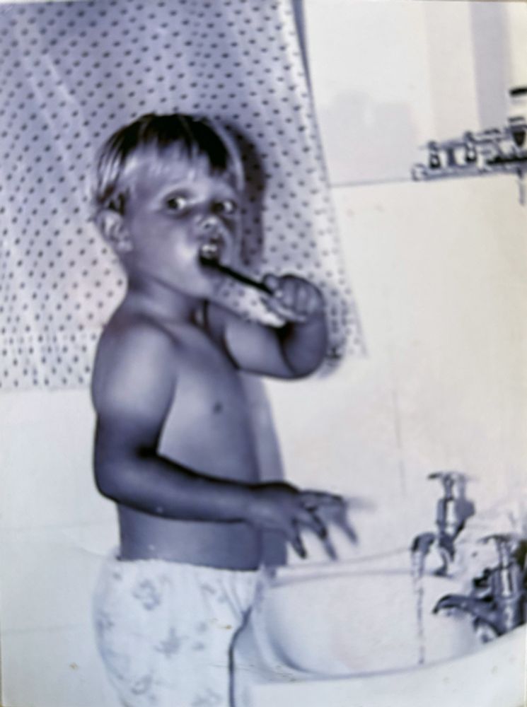 Me aged 4 brushing my teeth in the bathroom