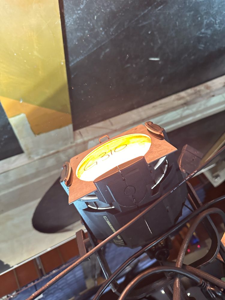 an etc source 4 par with a gel in it. The light is on. The gel is labeled g310