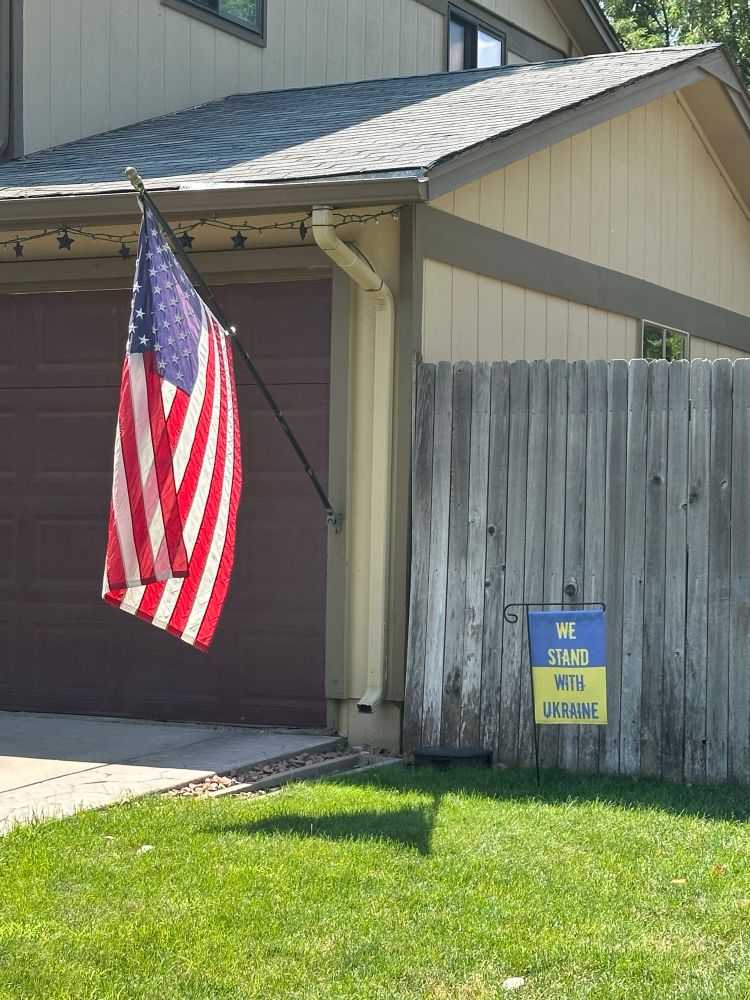 We stand with Ukraine flag by American flag. 