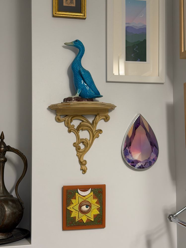 The same tile as part of a wall installation with other sculptures and paintings 