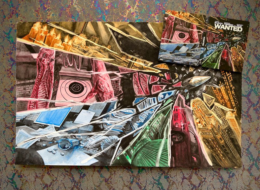 Photo of a large original watercolor illustration with the comparatively smaller final steelbook product sitting on top of it. See previous post for description of art details.
