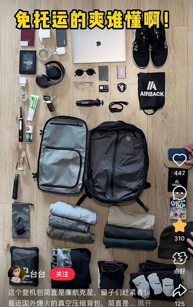 Image showing a bag in the middle of the frame with various items out out of the back so just clothing, items, toiletries, and electronics