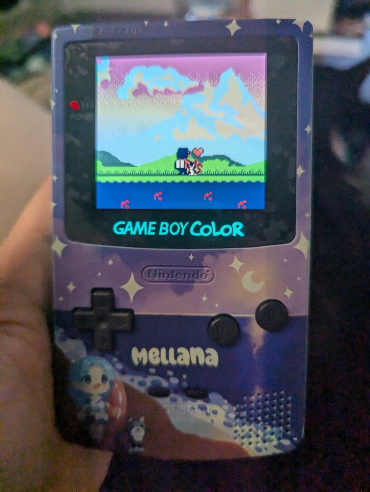 Lethal Company employee petting Luna (tuxedo cat) in a customized gameboy color
