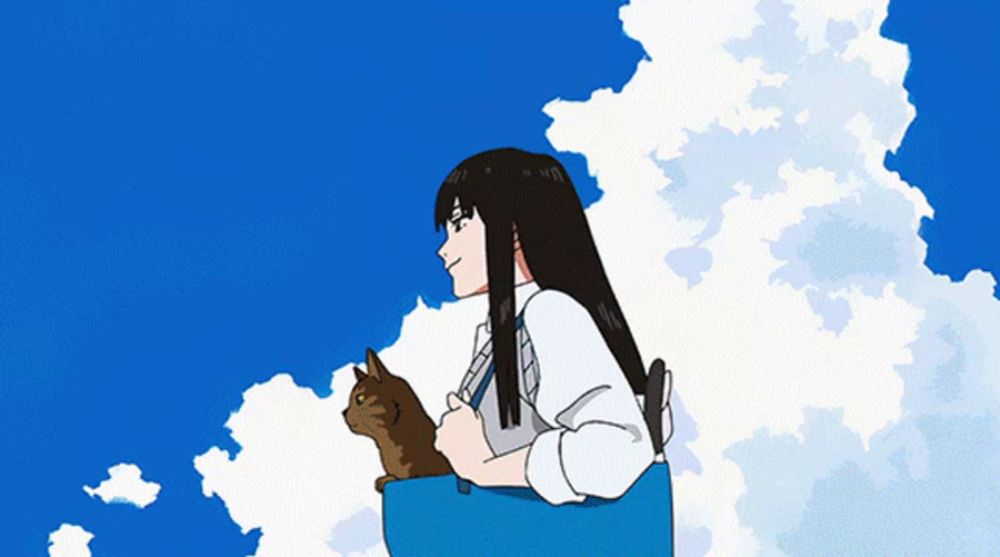 a girl holding a cat in a blue bag against a blue sky