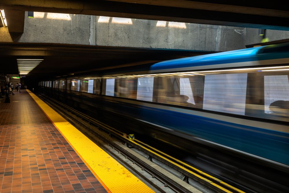 2019-09-22 Montreal, Quebec  - A long exposure color photo taken in the Montreal subway system. Looking down the platform a shaft of light illuminates a relatively empty red brick platform lined with vibrant yellow safety strip. A fast moving train is blurred along the far track mirroring the long yellow strip with equally vibrant blue.

Canon R 35mm f4 1/5sec iso125