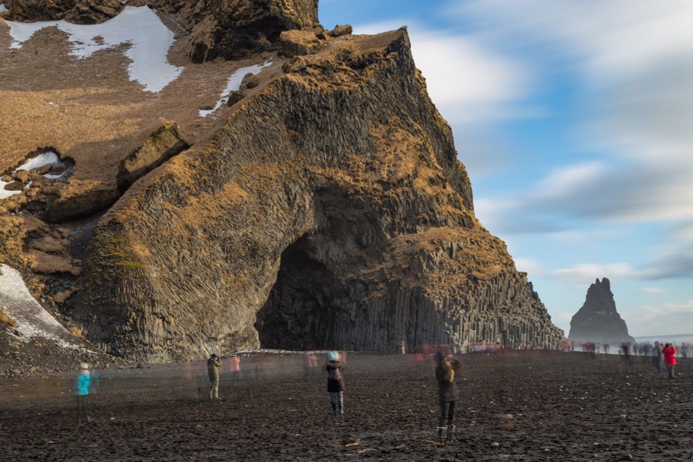 2018-02-22 Vik Iceland - Color Photo taken at the Black Sands beach, the exposure is extremely long showing many people darting along the beach as clouds smere in the background. A large arch of basalt columns raise out of the black sands in the background. Several figures stand idle amount the moving lines.

Canon 6D 40mm f13 25sec iso50