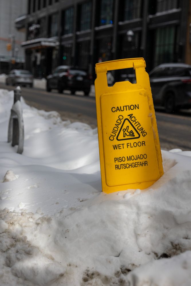 2025-02-17 Toronto Ontario Canada- Color photo of a bright yellow caution sign for 'wet floors' wedged into a snow embankment built up from recent snow storms.
Canon R6 70mm f5 1/800s iso125