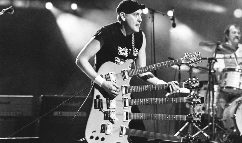 Rick Nielson of Cheap trick playing a 5 neck guitar. 