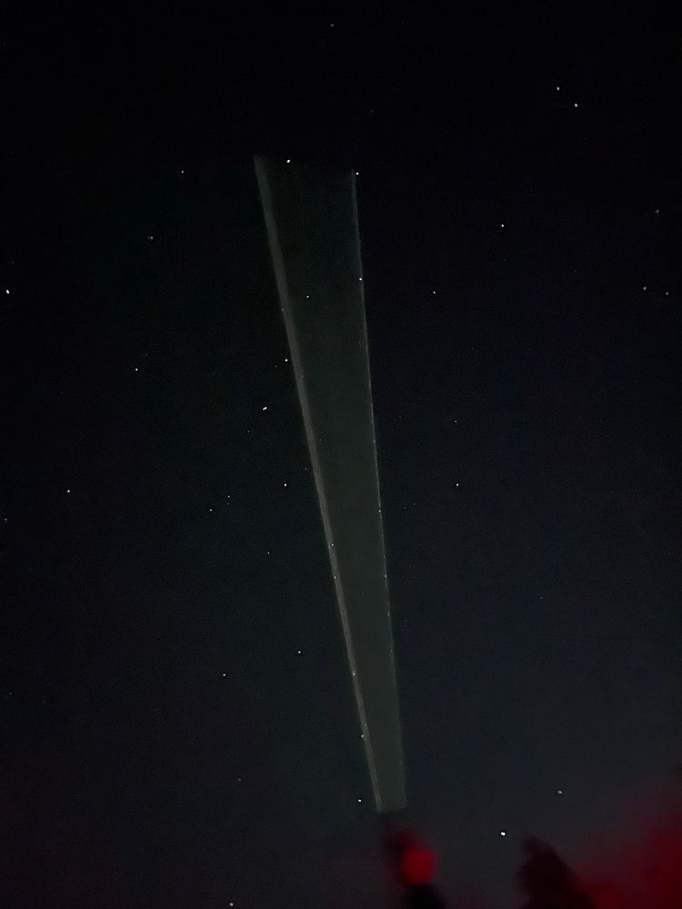 The laser pointer against a dark but starry sky showing us where to look with our binocs. 