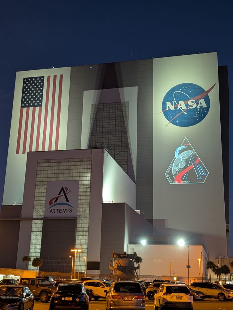 NASA VAB at KSC with the Artemis II mission patch projected.
