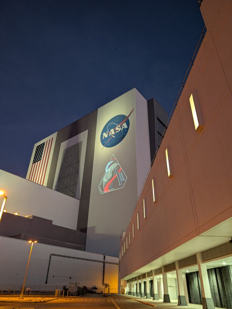 NASA VAB at KSC with the Artemis II mission patch projected and the LCC