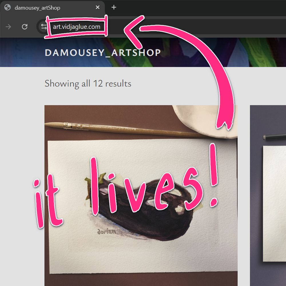 Screen capture of the top of broswer showing the online store with the URL, art.vidjagle.com highlighted. The words "it lives!" is scrawled over the picture.
