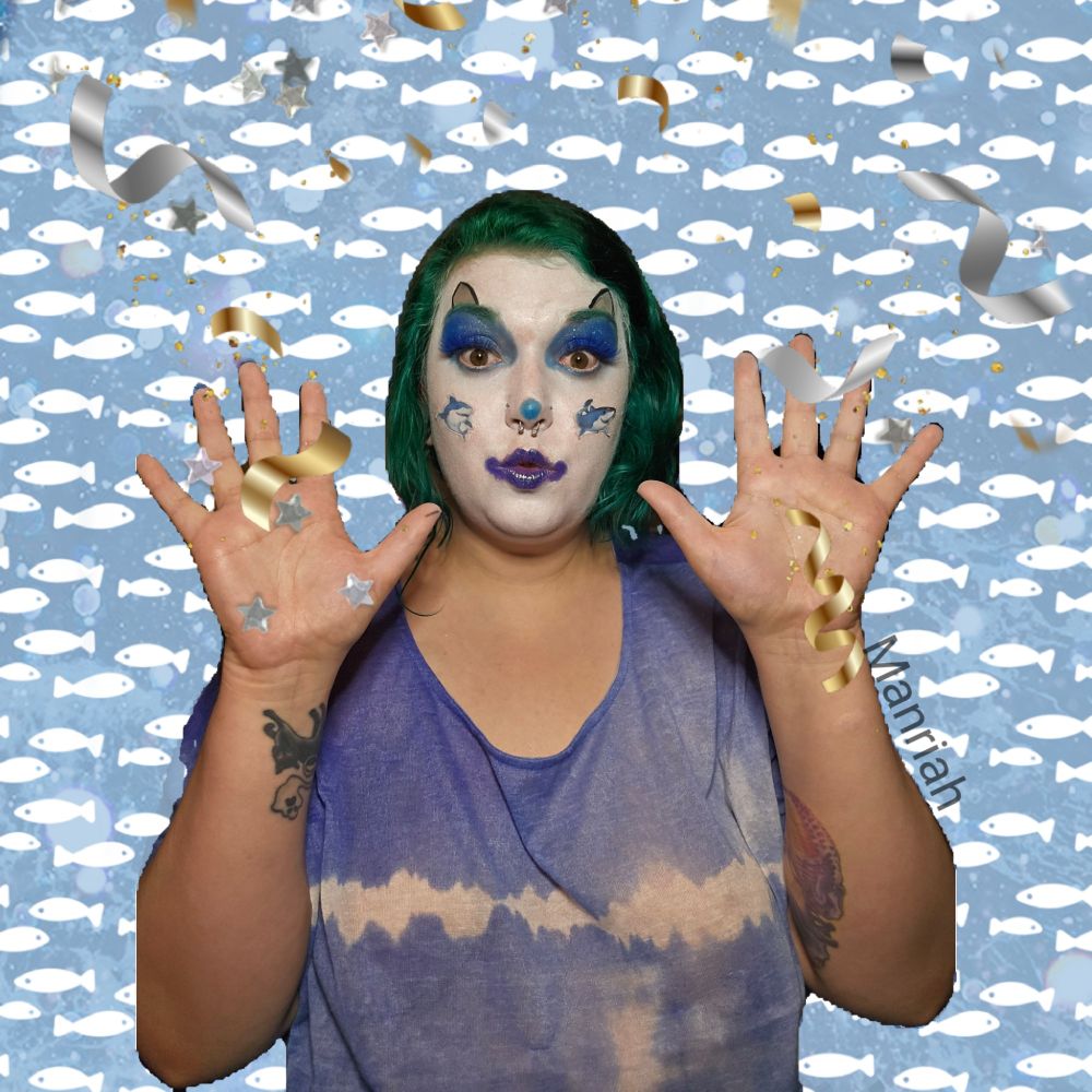 Manriah wearing shark clown makeup shooting confetti from their hands 