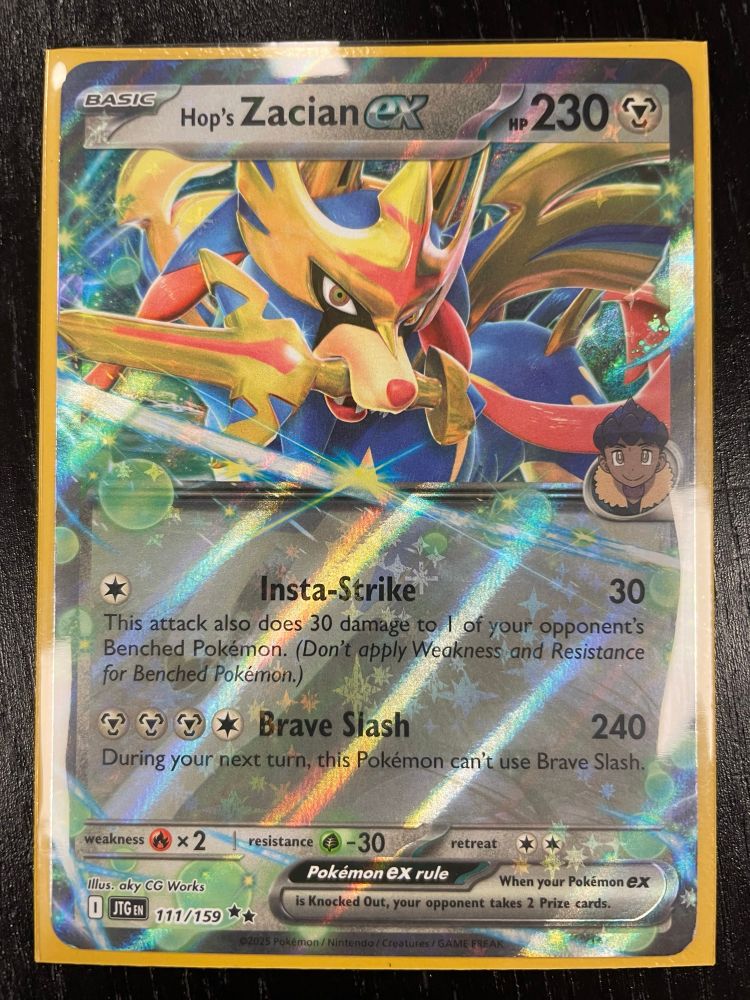 A Pokemon card: Hop’s Zacian ex from the Journey Together set. It is in a yellow sleeve. 