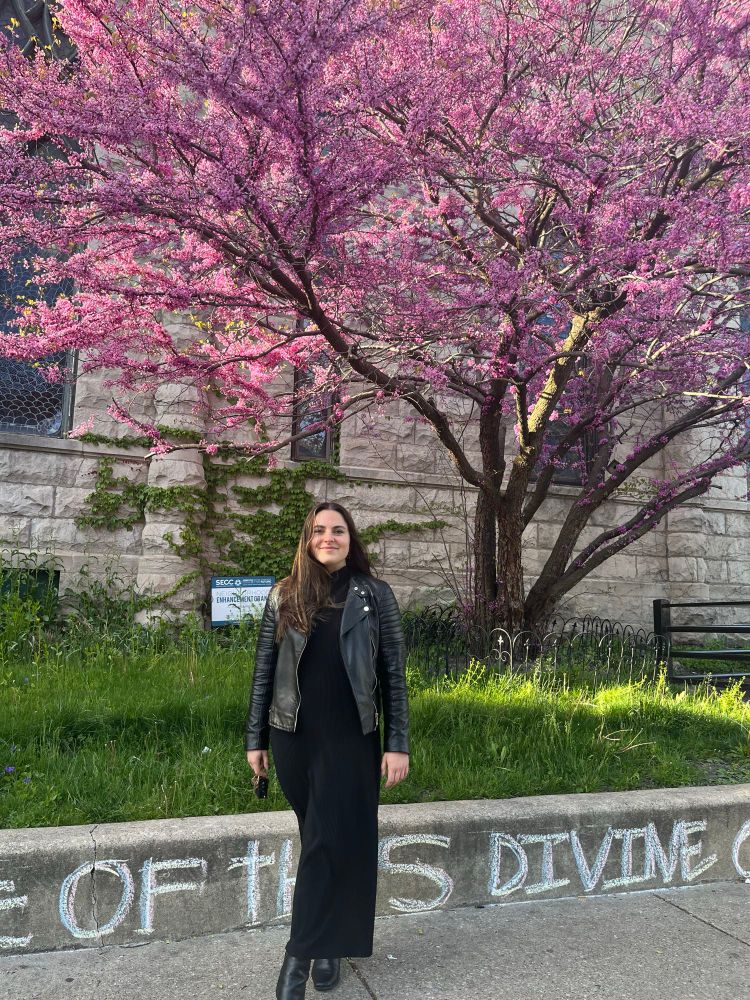 me when i was 27 standing in front of a pink flowering tree!