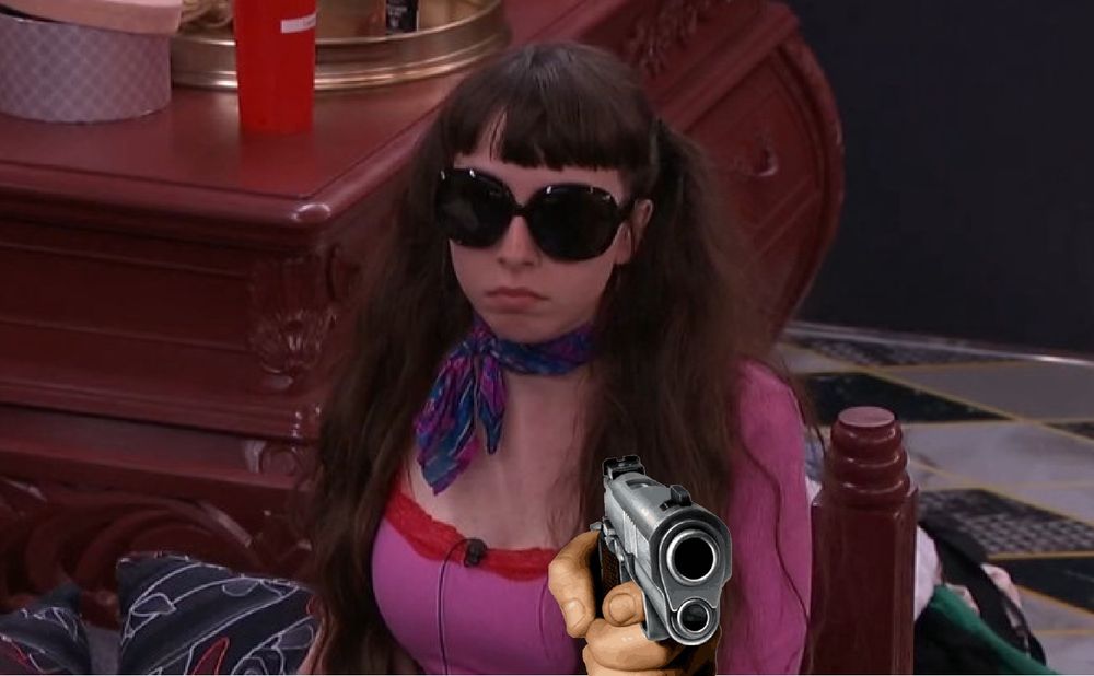 Ava Pearl wearing a purple ascot and a put body suit digitally altered to be holding a gun