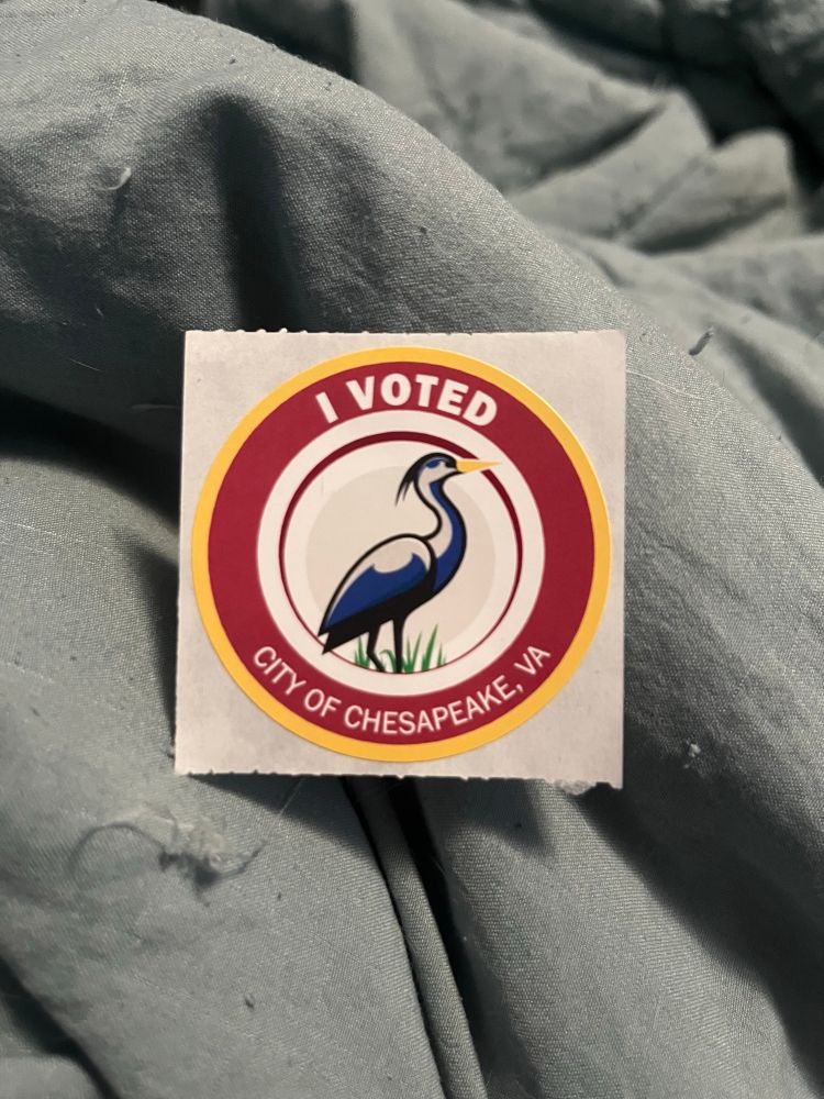 I voted sticker that has red, white, and yellow rings a blue heron in the middle and the City Of Chesapeake, VA at the bottom