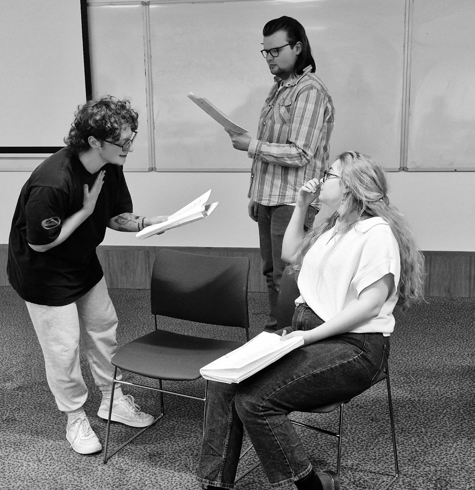 A group of three actors rehearsing a scene