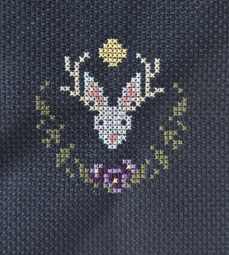 A tiny jackalope with purple flowers and a full moon. 