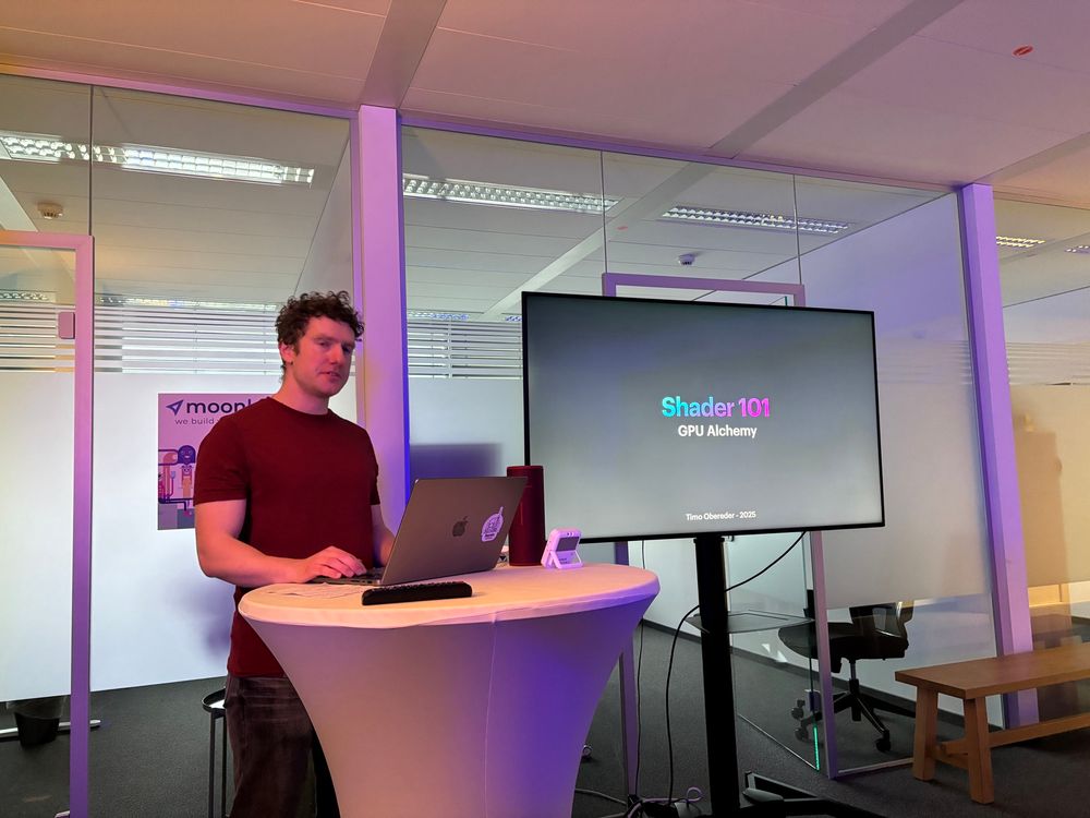 Timo on stage, "Shader 101" slide in the background 