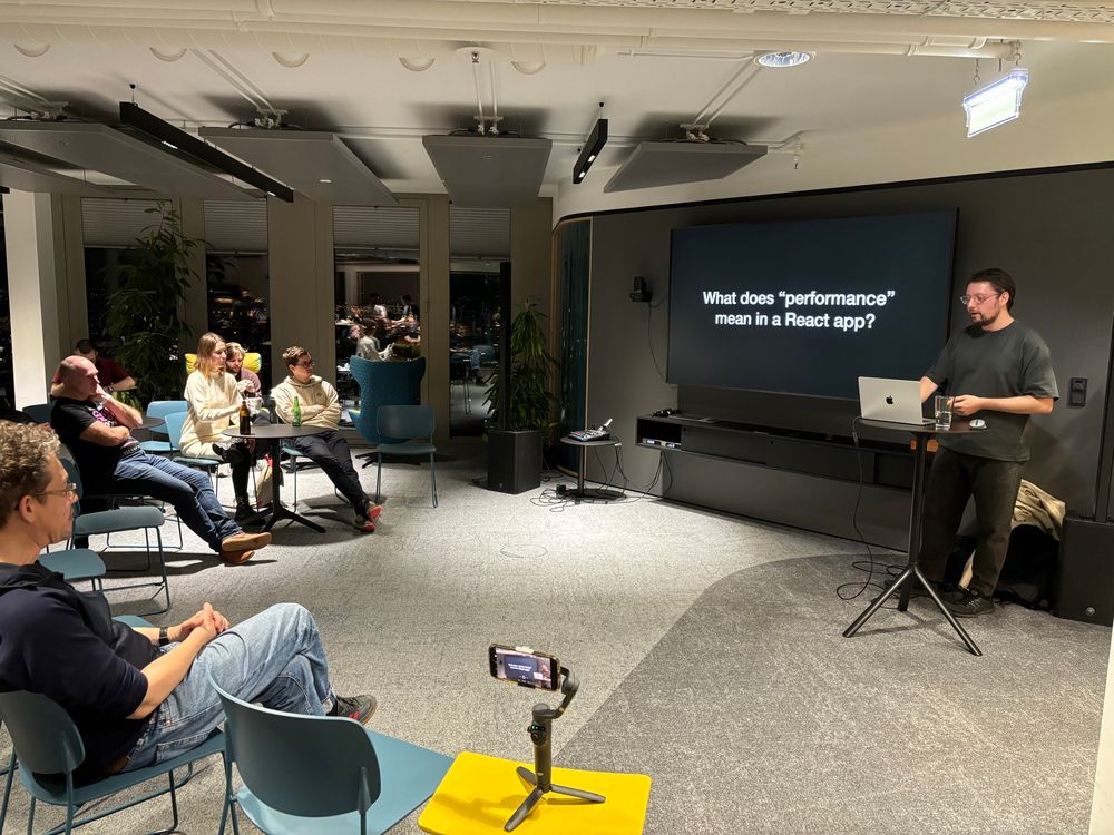 Chris presenting, slide saying: What does "performance" mean in a React app?