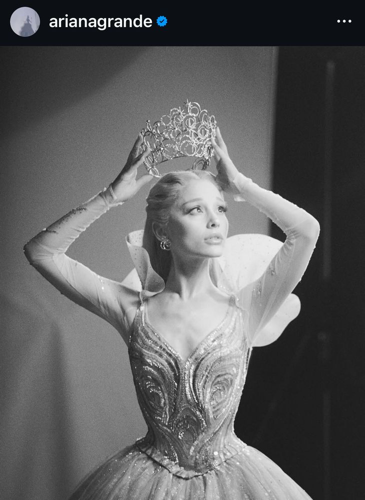 a photo from ariana grande’s recent post that features her in what is presumed to be her “thank goodness” dress, and her hands placing the bubble crown on her head