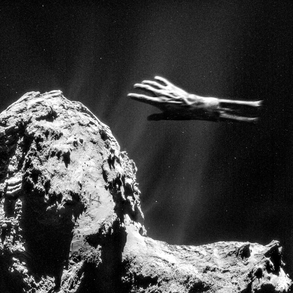 A grainy black-and-white photo of a rocky comet. In front of the camera floats a disembodied human hand, a broken radius and ulna jutting out of its still-intact skin.