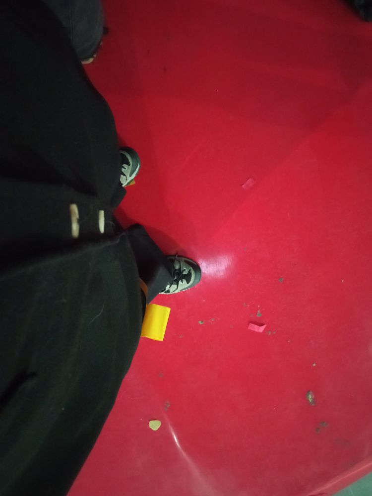 Standing on a red round piece of the floor