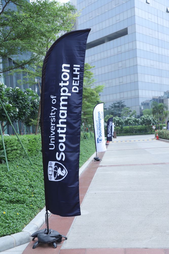 University of Southampton Delhi campus' vertical banner along a sidewalk featuring the university's logo. 