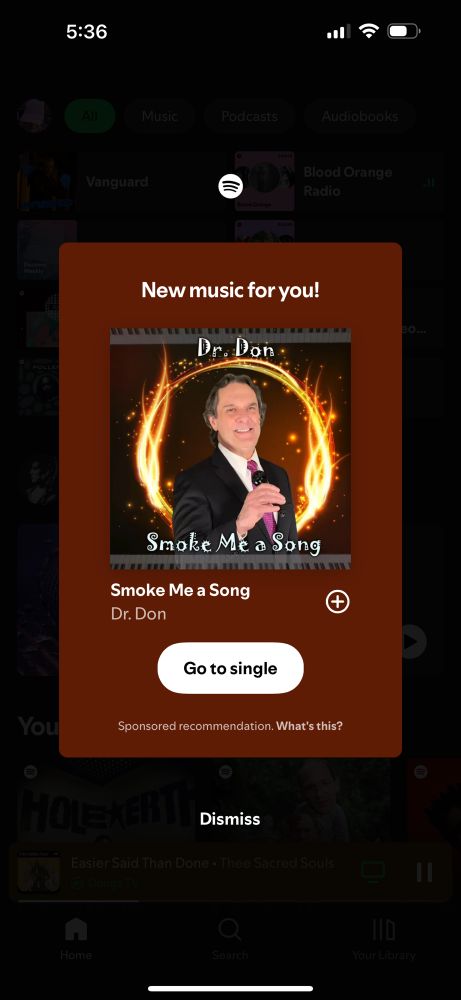 screenshot of a ‘New music for you!’ pop up. it’s a song by Dr. Don called ‘Smoke Me a Song’. the album art is a guy in a suit holding a mic with some bad graphic design and joker font.